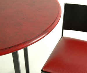 Closeup of black and red bisttro bar set with red granite wood top