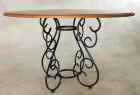 Wrought iron dining table base with round wood top